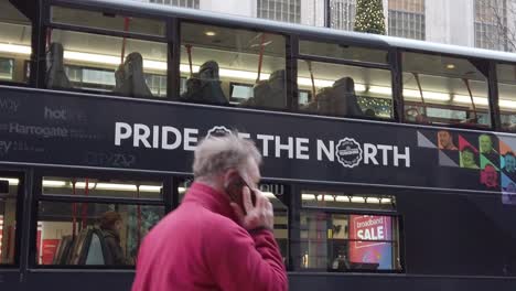 Slow-motion-Pride-of-the-North-man-passes-bus-with-slogan-promoting-growth-in-the-North-of-England