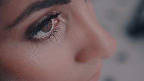 A-closeup-of-a-woman-with-makeup-opening-his-eyes-in-slow-motion