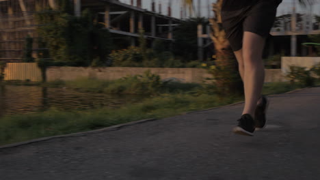 Masculino-Corriendo-Parque-Lago-Atardecer-Tiro-Bajo