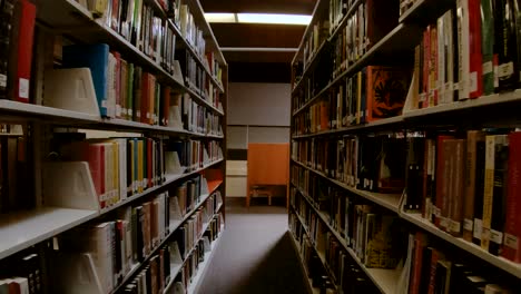 Slo-Mo-shot-walking-through-an-aisle-of-a-public-library
