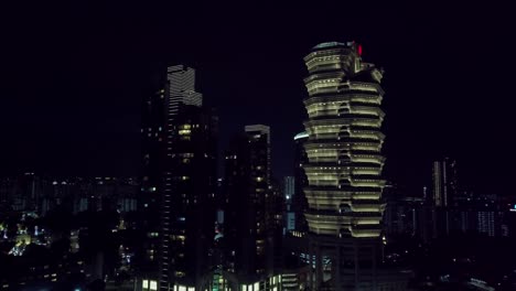 Aerial-approach-drone-shot-of-Singapore-skyscrapper-at-night