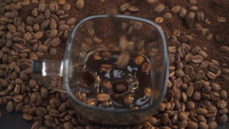 Cup-of-coffee-with-coffee-beans-falling-en-slow-motion