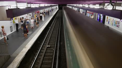 Green-trains-of-the-Paris-subway-system-arrive-and-depart-a-metro-station-as-passengers-wait