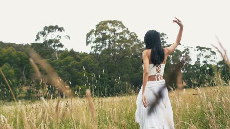 Dancing-in-a-beautiful-grass-meadow--low-view-slow-motion