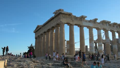 Tourists-enjoying-the-Parthenon-Temple-at-Acropolis-hill,-Athens,-Greece