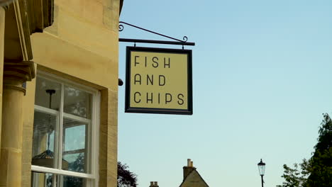 Fish-and-chip-sign-in-bourton-on-the-water,-typical-english-fish-and-chip-sign-for-gourmet-fried-foods