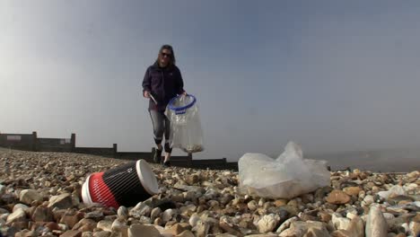 A-volunteer-scours-the-beach-for-rubbish