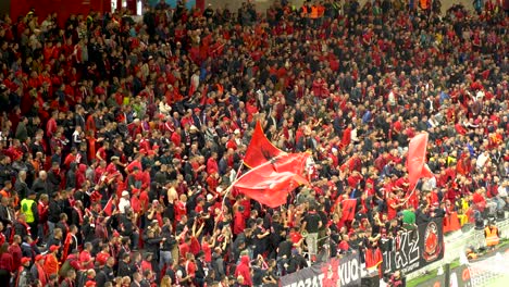 Enthusiasm-of-the-supporters-of-the-Albanian-national-team-with-waving-flags-on-crowded-stadium-during-football-match-with-France