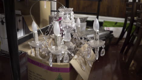 Interior-of-an-old-chandelier-on-the-floor-in-a-cardboard-box-during-a-restaurant-renovation