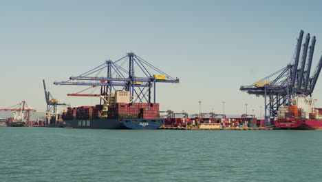 Port-docks-with-cargo-ships-full-of-containers-for-loading-and-unloading-containers-in-the-port-of-Valencia,-Spain