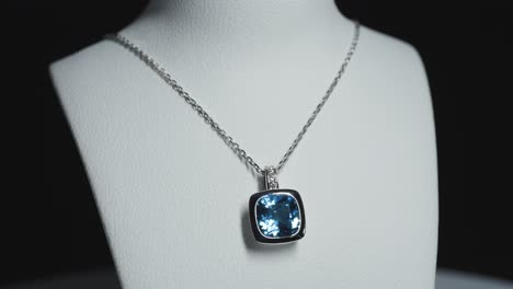 Blue-gemstone-on-a-necklace-on-a-rotating-bust