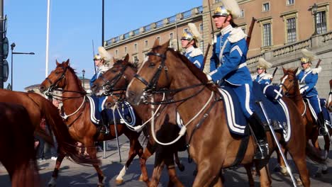 Ceremonial-Royal-Guards-on-horseback-by-Stockholm-Palace,-slow-motion