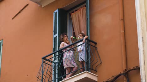 Boy-on-a-small-balcony-blowing-bubbles