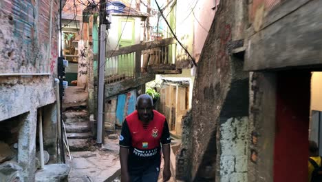 Man-walking-through-the-alleys-of-Rocinha-in-Rio-de-Janeiro,-Brazil