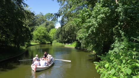 A-boat-sailing-in-a-green-nature-park-in-Copenhagen-during-a-summer-day