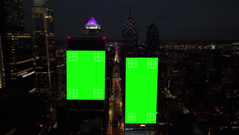 Green-screen-animated-on-dark-skyscrapers-in-American-city-at-night