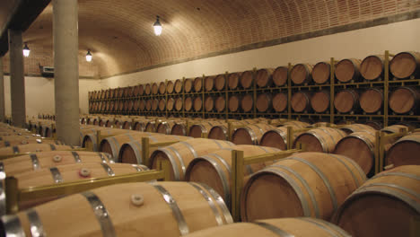 Slow-motion-wide-shot-of-a-container-of-wine-barrels-in-a-wine-factory-in-Burgos,-Spain