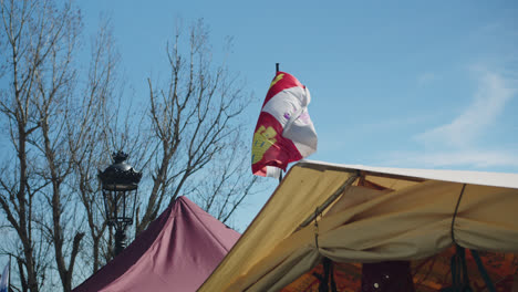 Beautiful-shot-of-the-flag-of-Huelva,-Spain-during-a-medieval-fair-in-Huelva,-Spain