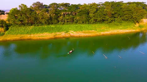 Fishing-Boat-On-Tranquil-Surma-River-In-Bangladesh---Aerial-Shot