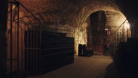 General-shot-of-a-dimly-lit-underground-wine-cellar-in-Burgos,-Spain