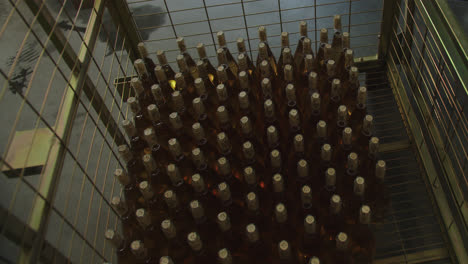 Amazing-wide-shot-of-machinery-that-fills-wine-bottles-inside-a-wine-factory-in-Burgos,-Spain-in-4k