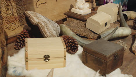 Beautiful-slow-motion-shot-of-medieval-and-Buddhist-objects-like-chests-at-a-stall-inside-the-medieval-fair-of-Huelva-in-Spain-during-a-summer-morning