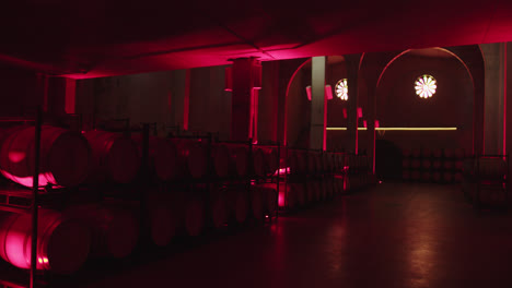 Amazing-shot-of-a-beautiful-container-of-wine-with-neon-red-color-of-barrels-inside-a-wine-factory-in-Burgos,-Spain