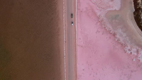 Cars-Parked-In-The-Point-Sinclair-Road-By-The-Lake-Macdonnell-And-Pink-Lake-In-Penong,-South-Australia