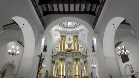 White-chapel-interior-with-gold-altar-piece-decorations-in-Medellin-Colombia