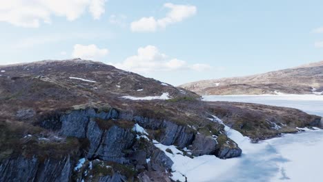 Flying-Over-The-Frozen-Lake-To-The-Rocky-Mountains-In-Leknes,-Vestvagoy,-Nordland,-Norway