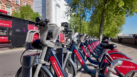 The-Santander-hire-bikes-stationed-at-Westminster-represent-London's-public-bike-sharing-scheme,-symbolizing-sustainable-urban-mobility-and-accessibility