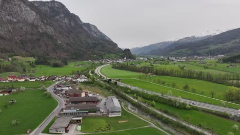 Road-with-passing-cars-through-a-valley-between-the-mountains-near-the-town-of-Walenstadt