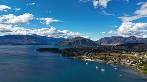 Wanaka-Lakefront-and-Roys-Bay-New-Zealand-on-sunny-day,-aerial-dolly-hyperlapse