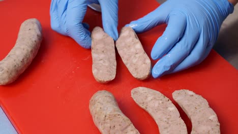 The-butcher-tests-the-produced-sausage-by-slicing-it-in-half-with-a-sharp-knife