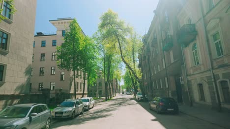Flying-through-central-European-old-retro-street-with-sun-and-lens-flare