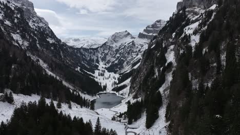 Close-up-drone-view-of-frozen-mountain-lake-Tahlalpsee-Filzbach-Glarus-Nord-Schweiz