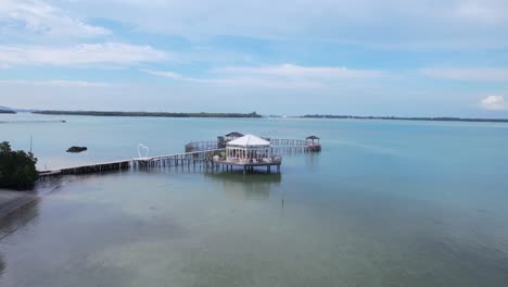 Aerial-landscape-of-a-restaurant-floating-in-the-middle-of-the-sea-with-seascape-and-clear-sky-in-Leebong-Island-Belitung-Indonesia