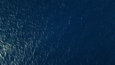 Bird's-eye-view-static-shot-of-ocean-water-current-ripples-textured-across-sea-surface