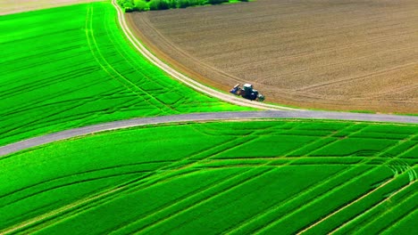 Tractor-Tending-Fields:-Lush-Green-and-Earthy-Brown-Aerial-Farmland-View