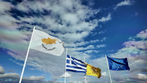 A-dynamic-display-of-flags-including-the-Cypriot,-Greek,-and-Ukrainian-flags-against-a-vibrant-sky-with-dramatic-clouds