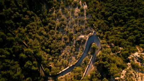 Serpentine-road-winding-through-lush-greenery-in-Sant-Salvador,-Mallorca