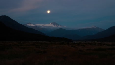 Time-lapse-moon-traveling-over-snowy-mount-hooker-in-New-Zealand-landscape