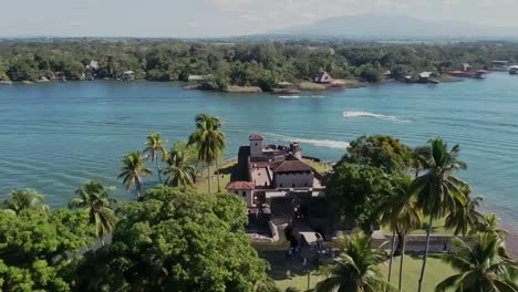 Orbiting-Drone-Shot-above-hispanic-fortress-and-tourist-attraction-of-San-Felipe-Castle-Rio-Dulce-Izabal-Guatemala