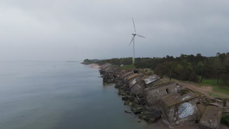 Establishing-Aerial-View-of-Abandoned-Seaside-Fortification-Building-at-Karosta-Northern-Forts-on-the-Beach-of-Baltic-Sea-,-Overcast-Day,-Wide-Drone-Shot