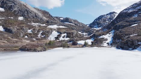 Flying-Above-Frozen-Palvatnet-Lake-In-Norway---Drone-Shot