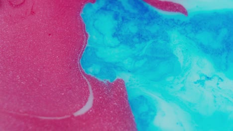 Vivid-abstract-swirls-of-pink-and-blue-ink-diffusing-in-water,-vibrant-and-fluid