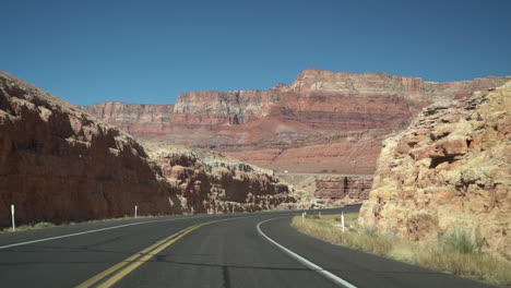 Driving-on-State-Road-in-Dry-Desert-American-Landscape,-Driver's-POV