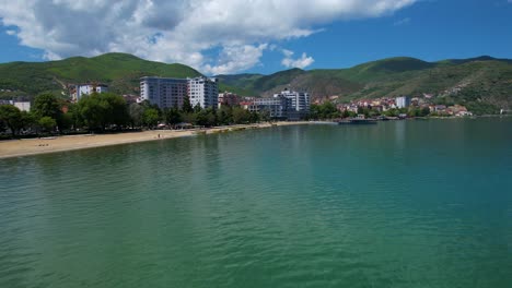 Tranquil-Lake-Reflects-Pogradec's-Beautiful-Springtime,-Destination-for-Relaxation,-Leisure,-and-Enjoyment