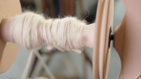 Closeup:-Freshly-spun-wool-yarn-collects-on-bobbin-of-spinning-wheel