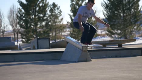 skater-does-trick-on-the-rail-at-the-skatepark-in-winter